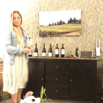 Relic Wine Cellars - a woman holding a glass of wine - Wineries Near Me - Napa, California Relic Wine Cellars - a woman holding a glass of wine - Wineries Near Me - Napa, California