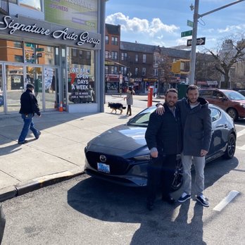 Signature Auto Group - Just got my new Mazda 3 Hatchback.  Taking a pic with Signature Auto owner Allan K. - Car Dealers Near Me - Brooklyn, New York