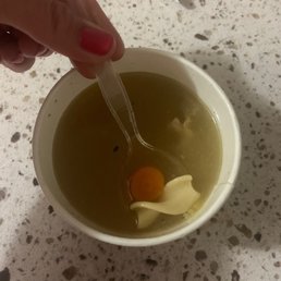 One noodle and a carrot in soup, chicken not included?