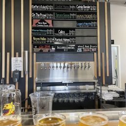 a row of beer glasses on a bar