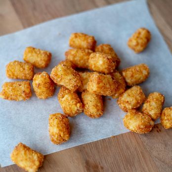 Jaggers - a pile of fried tater tots on a piece of wax paper - Burgers Near Me - Noblesville, Indiana