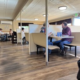 people sitting at tables in a restaurant
