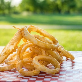 DBurger - a pile of onion rings on a table - Burgers Near Me - Pincourt, Quebec DBurger - a pile of onion rings on a table - Burgers Near Me - Pincourt, Quebec