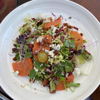 Benchmark - ARUGULA SALAD, arugula, blue cheese, roasted persimmon, pickled grapes, crispy pancetta, candied walnuts, white balsamic vinaigrette - New American Near Me - Santa Ana, California