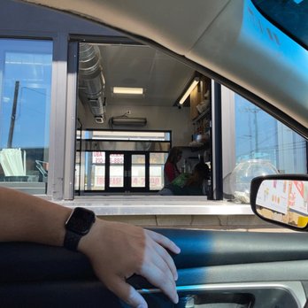 On The Grind - a hand on the steering wheel of a car - Coffee & Tea Near Me - San Antonio, Texas