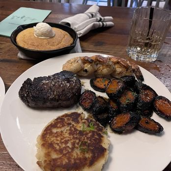 The Appalachian - Pan of cornbread, filet, grilled shrimp, potato cakes, grilled carrots - Steakhouses Near Me - Sevierville, Tennessee The Appalachian - Pan of cornbread, filet, grilled shrimp, potato cakes, grilled carrots - Steakhouses Near Me - Sevierville, Tennessee
