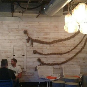 Nautilus Tavern - Wall logo and some dining room tables - American Near Me - San Diego, California