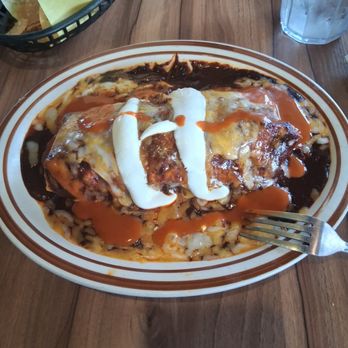 Super A's - Wet burrito poblano which is a mole sauce, cheese and sour cream. Filled with Barbecoa. - Mexican Near Me - Costa Mesa, California