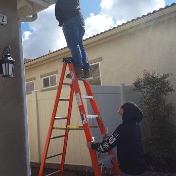 Rainbow Gutter - Ryan Helping Jefferie Caulk A Leaking Gutter Area - Gutter Services Near Me - Hemet, California