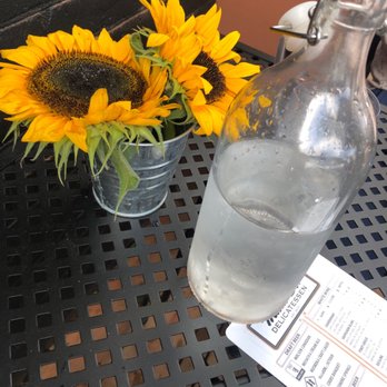 Main St. Delicatessen - a vase of sunflowers and a bottle of water - Delicatessen Near Me - Bracebridge, Ontario Main St. Delicatessen - a vase of sunflowers and a bottle of water - Delicatessen Near Me - Bracebridge, Ontario