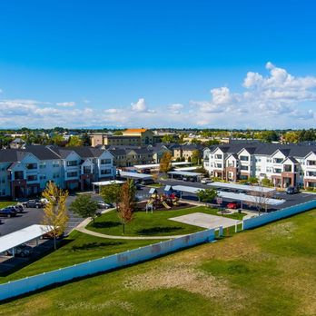 Eagles Landing Apartments - Aerial view of the Eagles Landing neighborhood with apartment buildings and a green area with a playground - Apartments Near Me - Ammon, Idaho Eagles Landing Apartments - Aerial view of the Eagles Landing neighborhood with apartment buildings and a green area with a playground - Apartments Near Me - Ammon, Idaho
