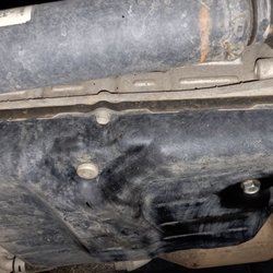 Michael's Toyota of Bellevue - Transmision pan after service was done the first time. Old gasket and overflow plug not even touched for accurate level