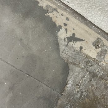 IAS Builders - wet spot that is clear it's from poured self leveler - General Contractors Near Me