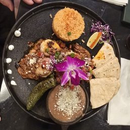 Off the Secret Menu, shrimp and birria with fresh tortillas, rice and beans along with a tangy grilled jalapeno.