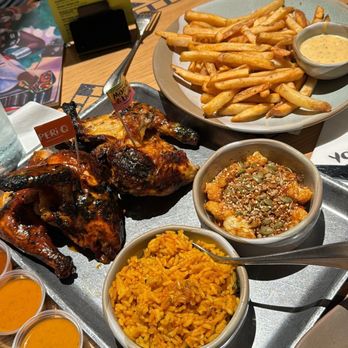 Nando's Peri-Peri - Full chicken platter with rice, fries, and cauliflower - Chicken Shop Near Me - Addison, Texas Nando's Peri-Peri - Full chicken platter with rice, fries, and cauliflower - Chicken Shop Near Me - Addison, Texas