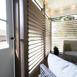 Wichita Home Works - Close-up of the screened porch door, structural wood framing, and horizontal privacy louvers.