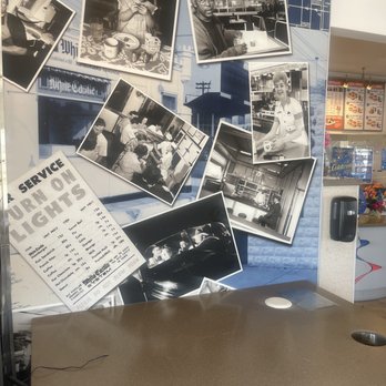 White Castle - a counter with a bunch of black and white photos - Burgers Near Me - Anderson, Indiana