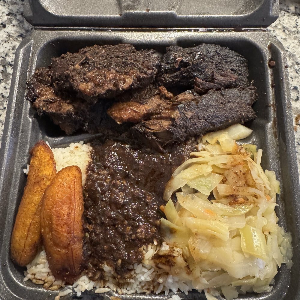 Jerk Brisket, white rice with oxtail gravy, cabbage and plantain.