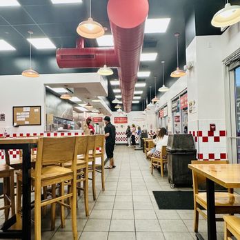 Five Guys - a restaurant with tables and chairs - Burgers Near Me - Kapolei, Hawaii Five Guys - a restaurant with tables and chairs - Burgers Near Me - Kapolei, Hawaii