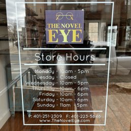 Exterior outside entrance of The Novel Eye - Store Hours Signage - North Kingstown, Rhode Island Exterior outside entrance of The Novel Eye - Store Hours Signage - North Kingstown, Rhode Island