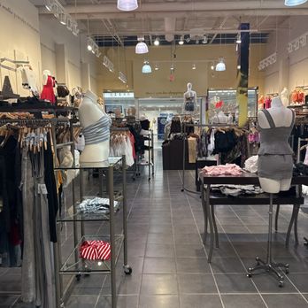 Windsor - Clothing - Interior of a clothing store featuring mannequins dressed in casual and swimwear, with racks of various garments and accessories. - Accessories Near Me - Virginia Beach, Virginia