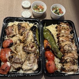 Pork rib combo on the left with basmati rice grilled vegs and Shirazi salad  Chicken thigh combo on the right