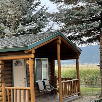Cabin Creek Inn - Cabin #5, porch with chairs and a stream behind the cabin - Hotels Near Me - Thayne, Wyoming Cabin Creek Inn - Cabin #5, porch with chairs and a stream behind the cabin - Hotels Near Me - Thayne, Wyoming