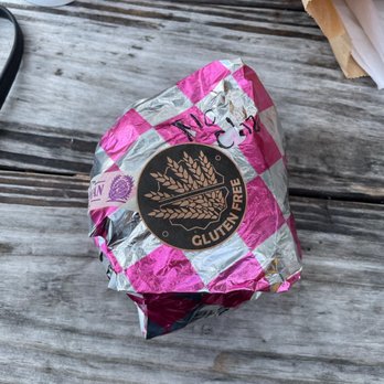 New Bohemian Cafe - a wrapped donut on a picnic table - Cafes Near Me - Northport, Michigan