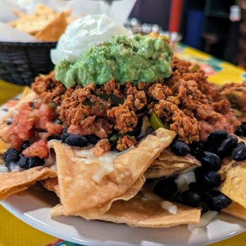 Carrburritos - Nachos. $8.75. Black beans, guacamole (+$3.75), housemade corn and flour chips, Monterey Jack cheese, sour cream, jalapenos, salsa fresca. - Mexican Near Me - Carrboro, North Carolina
