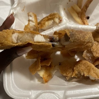 Sharks Fish and Chicken - a hand holding a piece of food in a styrofoam container - Food Delivery Services Near Me - Chicago Heights, Illinois Sharks Fish and Chicken - a hand holding a piece of food in a styrofoam container - Food Delivery Services Near Me - Chicago Heights, Illinois