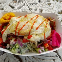 Afrodite tots with chicken and two eggs on top
