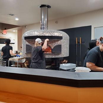 Sauced Up - people preparing food in a kitchen - Pizza Near Me - Magnolia, Texas
