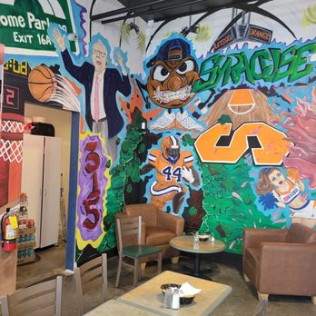 Over The Cuse Deli And Grill - Interior. Amazing wall art. - Delis Near Me - Syracuse, New York