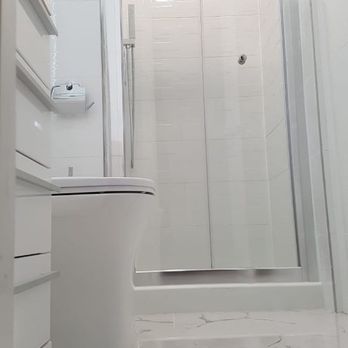 Osorio Construction - a bathroom with a toilet and shower - General Contractors Near Me