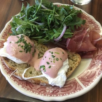 Publican Tavern - Their eggs Benedict, with a generous portion of prosciutto, red wine hollandaise, and an arugula salad lightly dressed with lemon and onion - New American Near Me - Chicago, Illinois