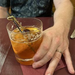 Old fashioned, sweet, with orange peel and cherry garnish Old fashioned, sweet, with orange peel and cherry garnish