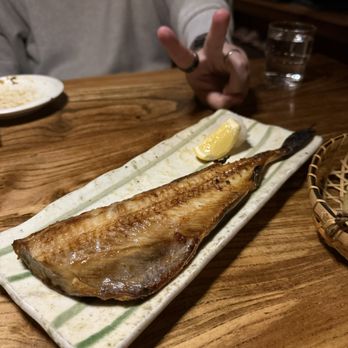 Ippuku - A grilled fish fillet served on a rectangular ceramic plate with a lemon wedge, on a wooden table in a restaurant setting. - Bars Near Me - Berkeley, California