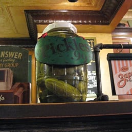 Jar of HUGE pickles at the counter. Jar of HUGE pickles at the counter.