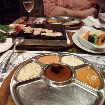 Grizzly House - Hot stone to cook the meats along with garlic butter and numerous sauces...Yummy! - Fondue Near Me - Banff, Alberta Grizzly House - Hot stone to cook the meats along with garlic butter and numerous sauces...Yummy! - Fondue Near Me - Banff, Alberta
