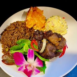 Blue Mermaid Gourmet - Griot/fried pork bits with black rice, baked mac and cheese, potato salad and garden salad