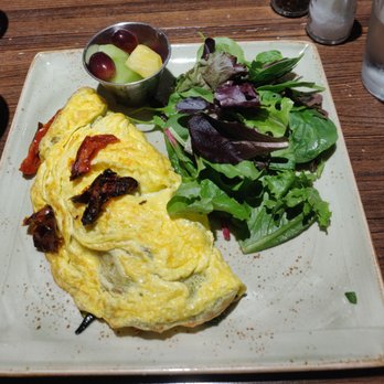 First Watch - Market vegetable omelette with sun-dried tomato, goat cheese, kale, zucchini, and mushrooms - Breakfast & Brunch Near Me - College Station, Texas First Watch - Market vegetable omelette with sun-dried tomato, goat cheese, kale, zucchini, and mushrooms - Breakfast & Brunch Near Me - College Station, Texas