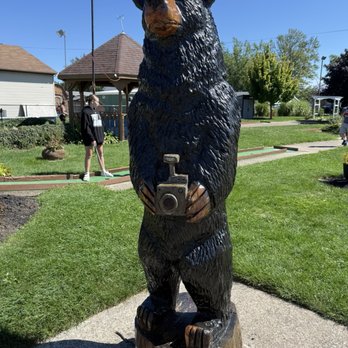 Allison's Mini Golf Course - Wooden bear with camera - Mini Golf Near Me - Geneva, Ohio Allison's Mini Golf Course - Wooden bear with camera - Mini Golf Near Me - Geneva, Ohio
