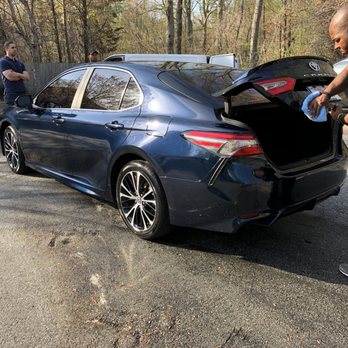 Davis Mobile Detailing - Davis is hard at work while my friend and I watch the art being worked on - Auto Detailing Near Me - Greensboro, North Carolina