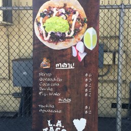 a taco menu on a sign