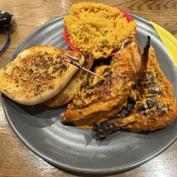 Nando's - Half chicken, garlic toast and spicy rice - Fast Food Near Me - Belfast, BFS Nando's - Half chicken, garlic toast and spicy rice - Fast Food Near Me - Belfast, BFS
