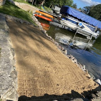 Sugar Creek Landscaping - sand being laid on the edge of a lake - Landscaping Near Me Sugar Creek Landscaping - sand being laid on the edge of a lake - Landscaping Near Me