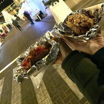 Eat My Weiners - a person holding a hot dog - Street Vendors Near Me