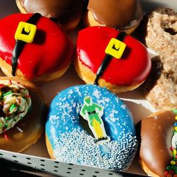 Krispy Kreme - Dozen Christmas Donuts Santa's Belly in the middle filled with Oreo frosting, YUM bottom left Buddy the Elf's breakfast MmMmm maple syrup!