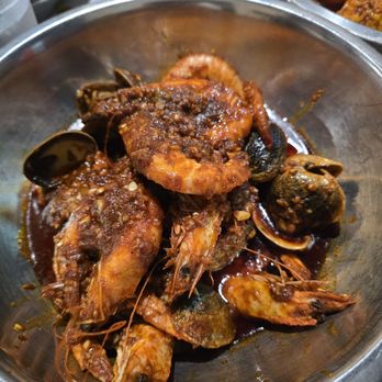 The Crawfish Hut - Head-on Shrimp and Manila Clams in Hut Special sauce with Flaming spice level - Seafood Near Me - Burien, Washington