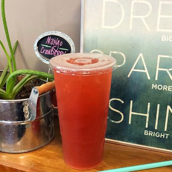 Madison Nutrition - a drink in a plastic cup on a wooden table - Juice Bars & Smoothies Near Me - Madison, Mississippi